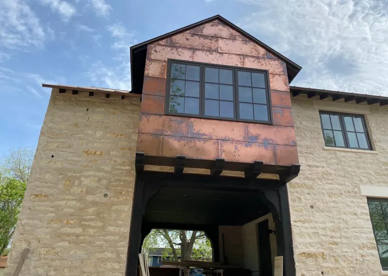 Copper metal panel facade on a stone building for Roof Repair in Vail