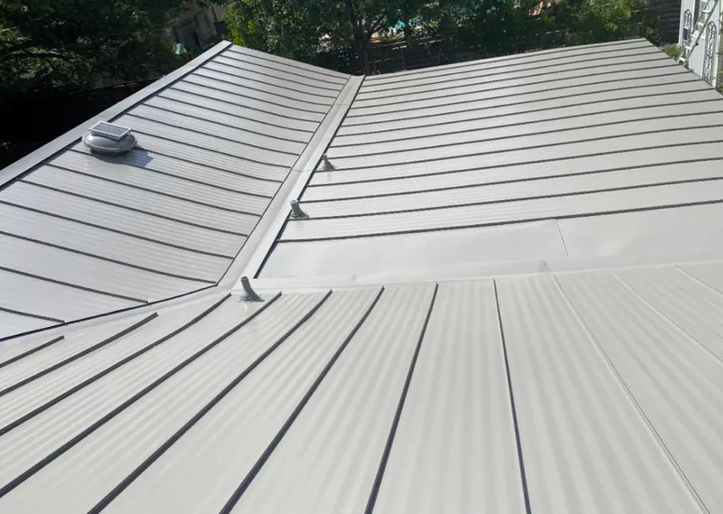 Solar attic fan installed on a metal roof for Roof Ventilation in Vail